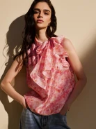 Pink blouse with a colorful patterned sash
