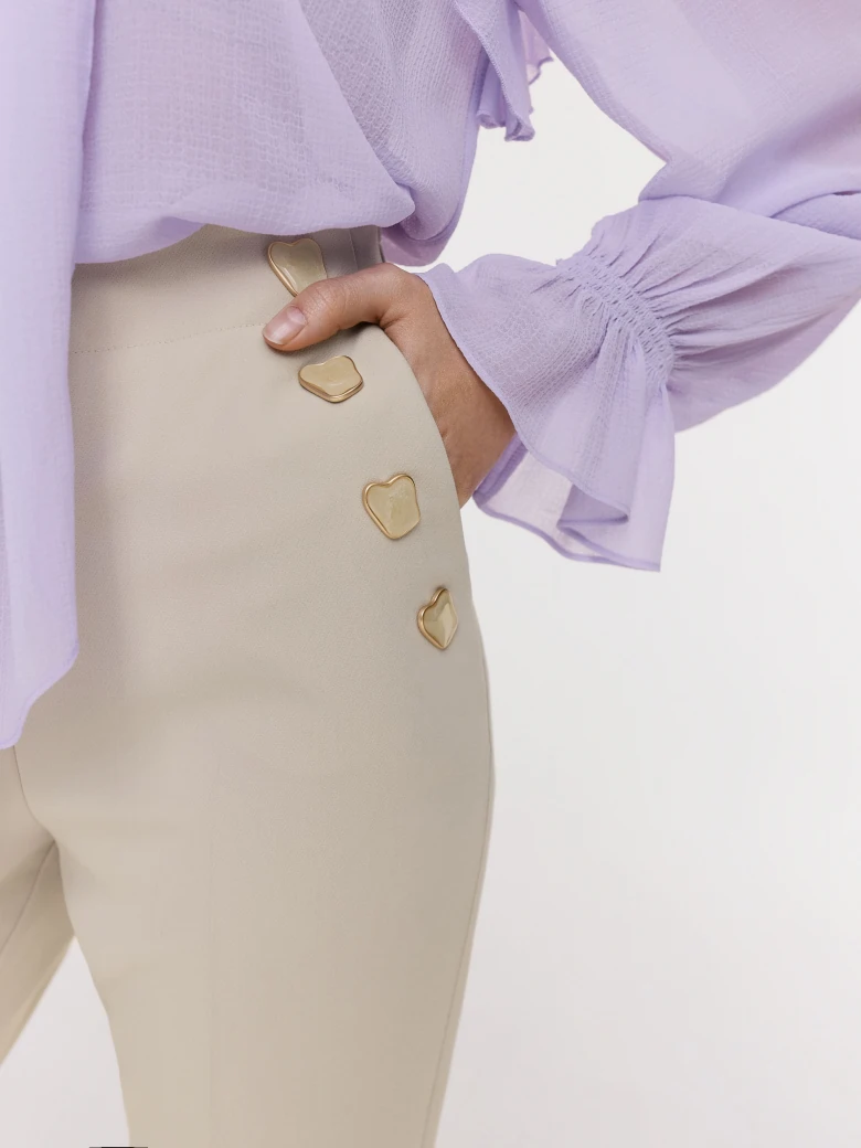 Beige cigarette pants with decorative buttons