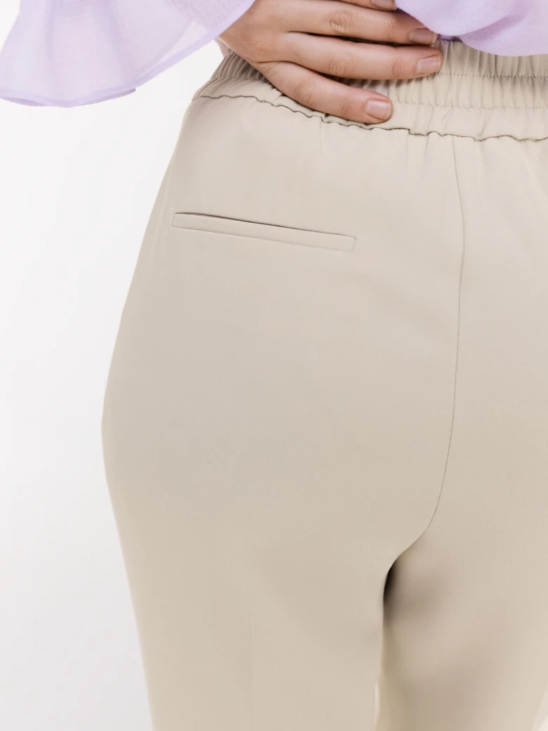 Beige cigarette pants with decorative buttons
