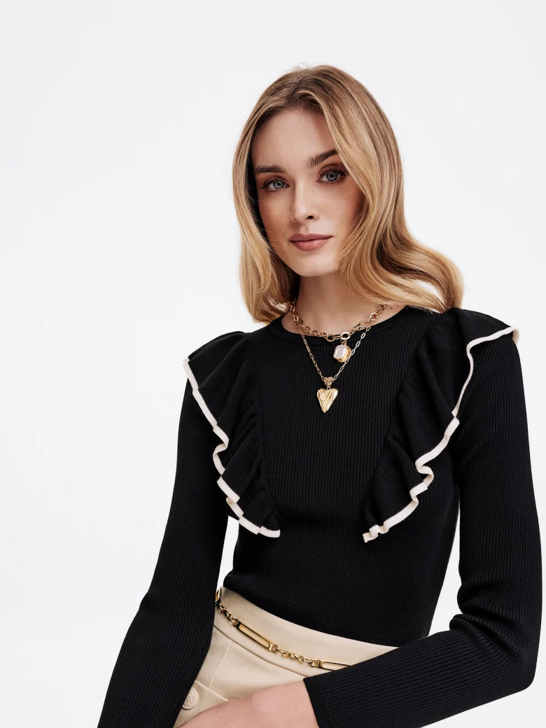 Black sweater with decorative ruffles