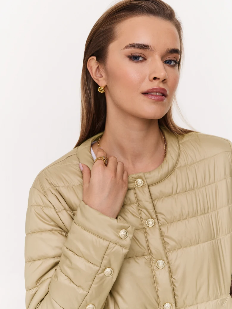 Beige quilted jacket with decorative buttons