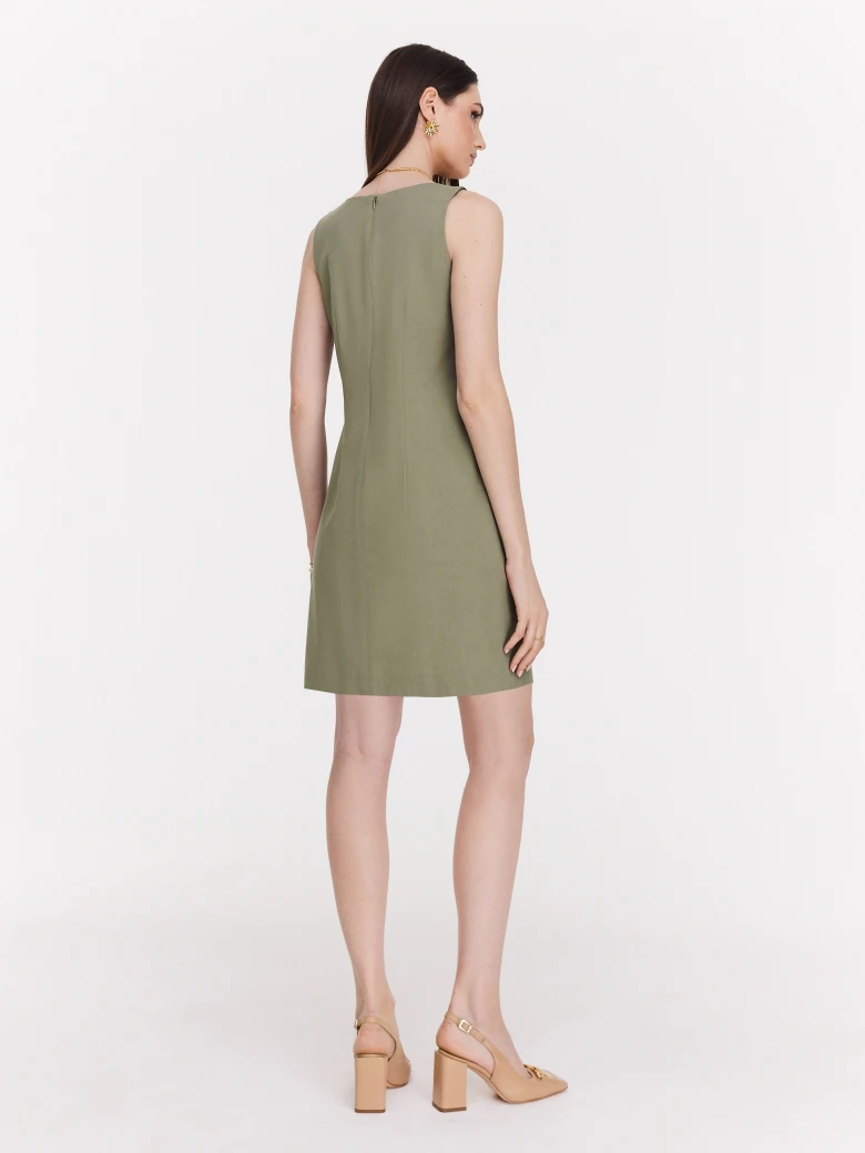 Green minimalist dress with decorative clutch