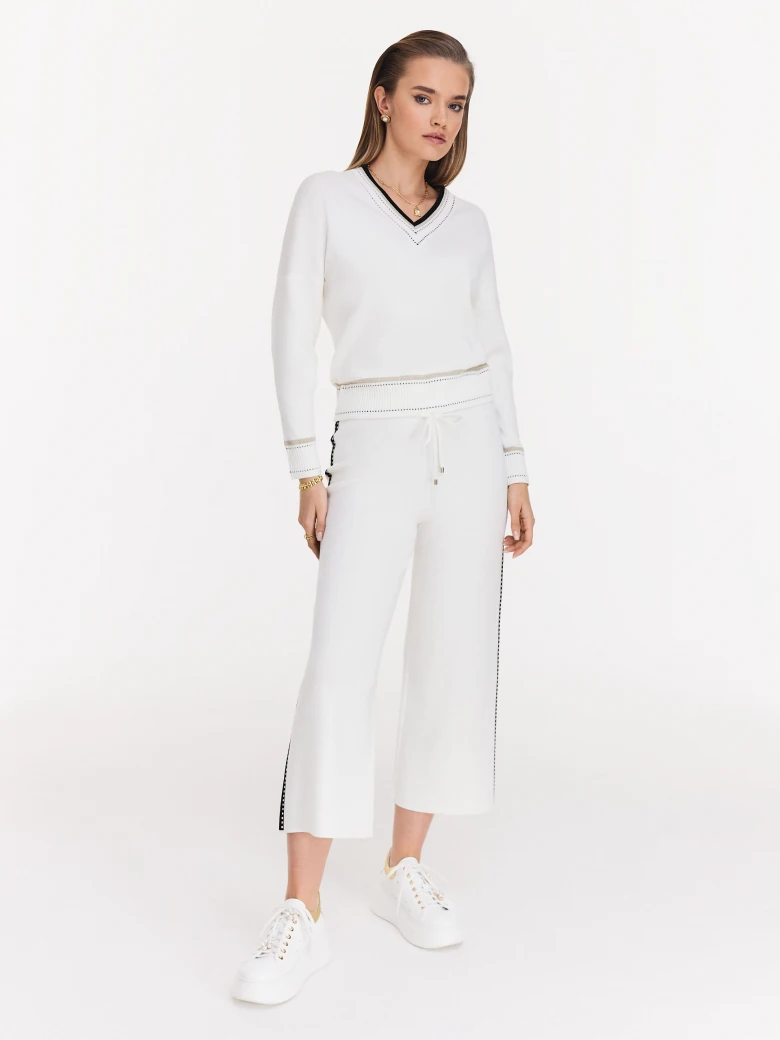 Cream high-waisted pants with black piping