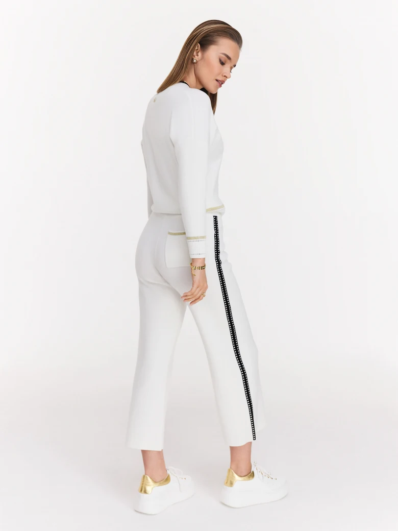 Cream high-waisted pants with black piping
