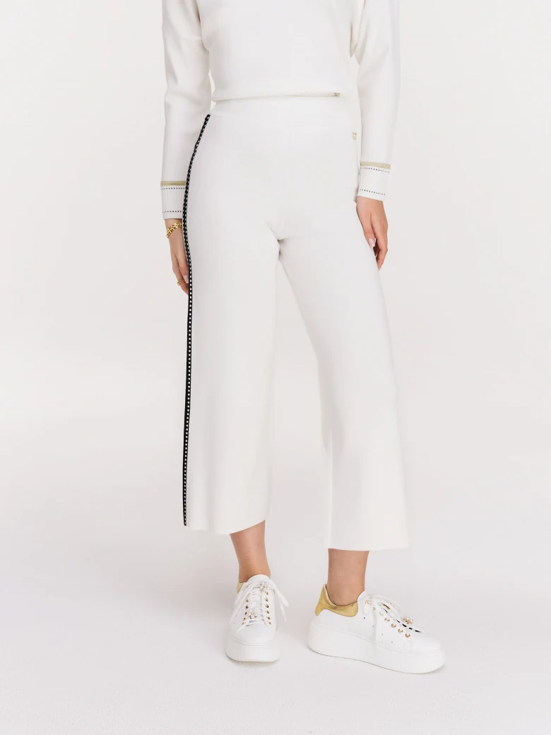 Cream high-waisted pants with black piping