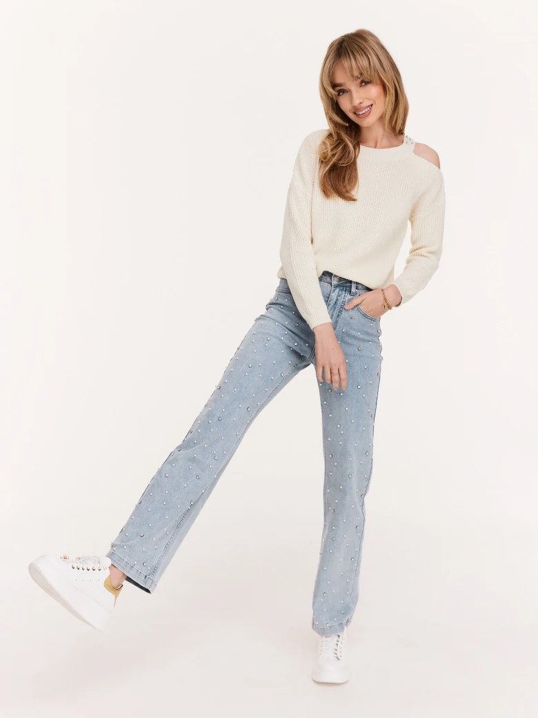 Cream sweater with striking cutouts
