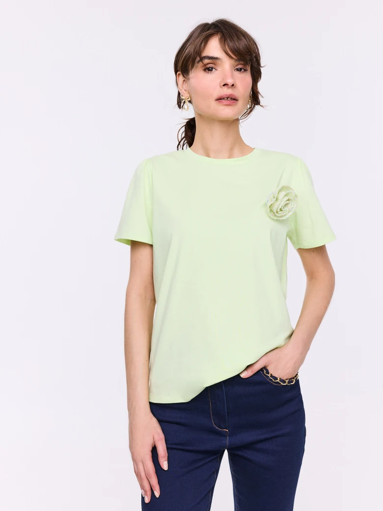 Lime short-sleeved blouse with a flower-shaped brooch