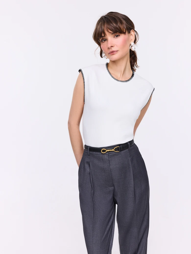 White sleeveless blouse with decorative trim
