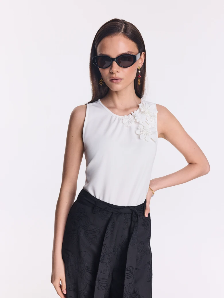 White blouse with floral appliqué