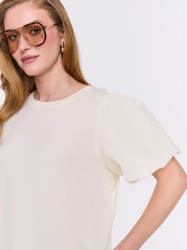 Cream-colored blouse with decorative sleeves