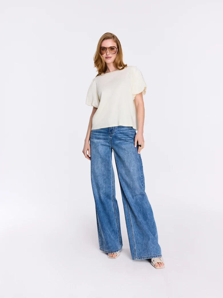 Cream-colored blouse with decorative sleeves