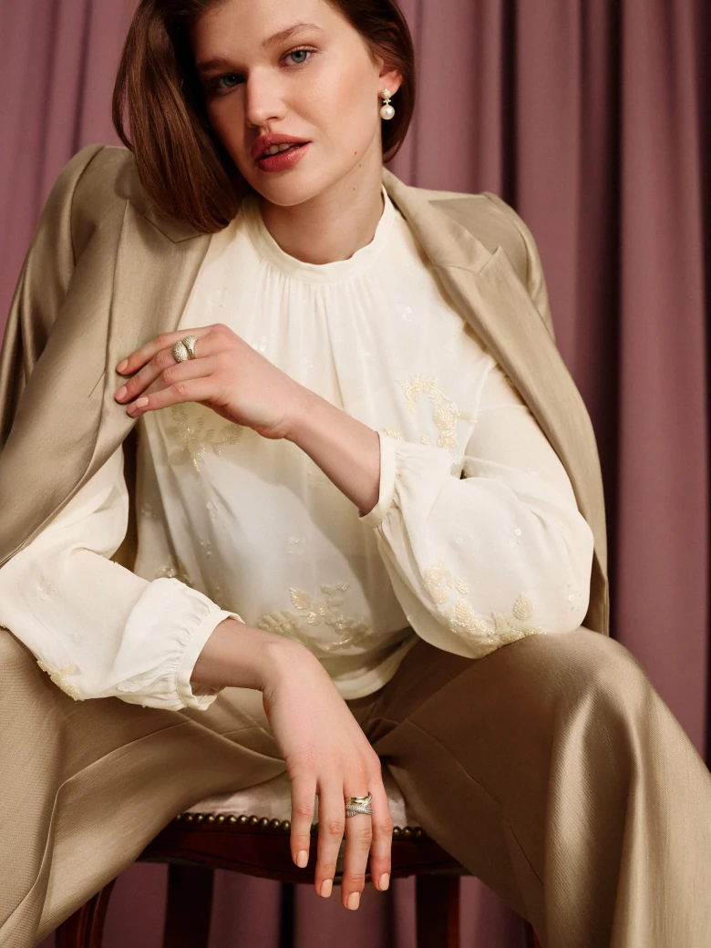 An elegant blouse with decorative appliqués
