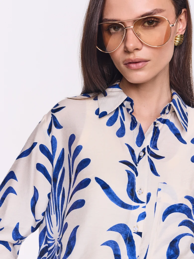 White oversized shirt with an ornamental pattern