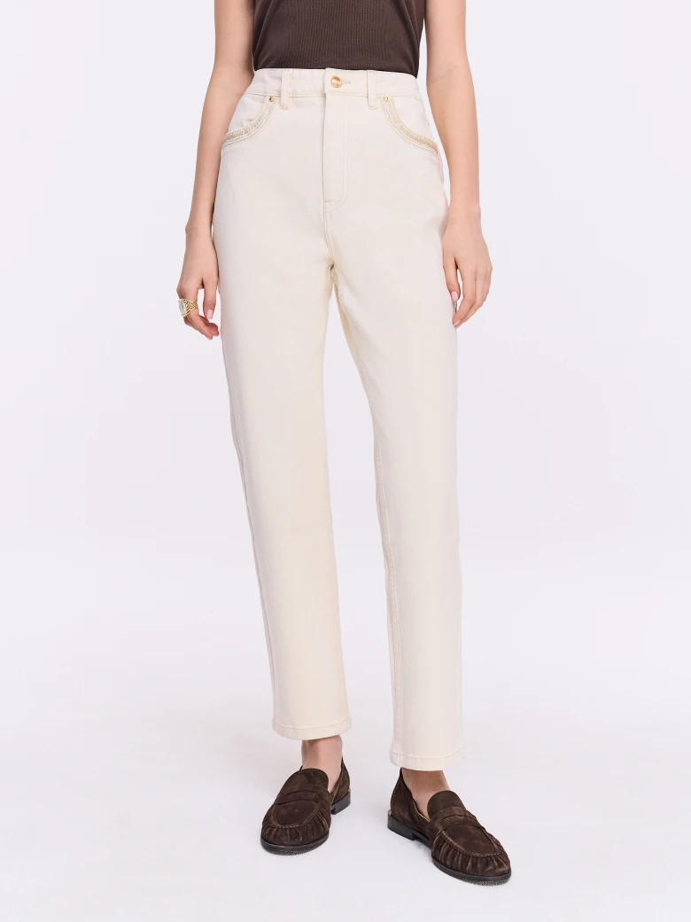 Cream-colored jeans with decorative embroidery