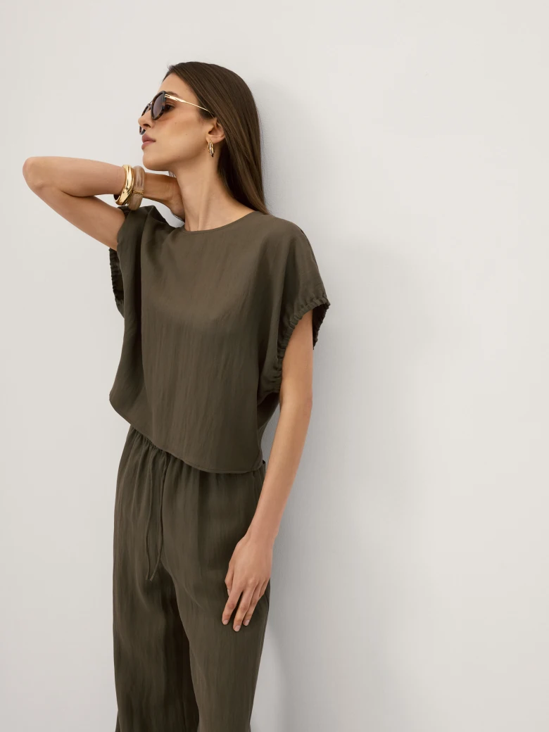 Olive-coloured blouse with a cut-out at the back
