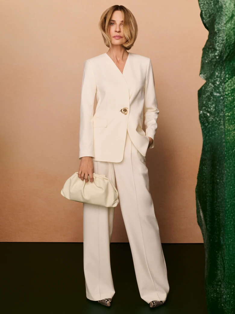 Cream jacket with decorative button and sash