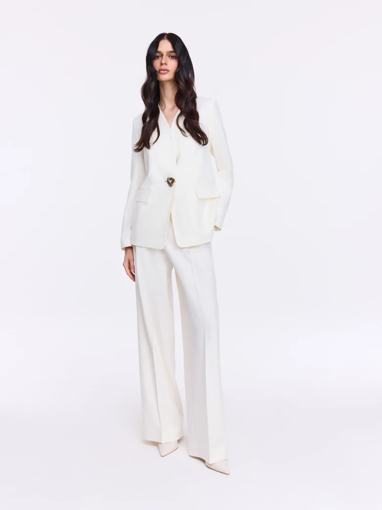 Cream jacket with decorative button and sash
