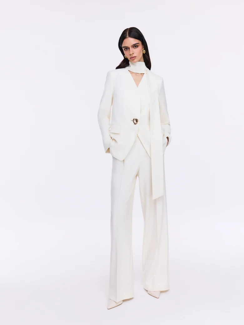 Cream jacket with decorative button and sash