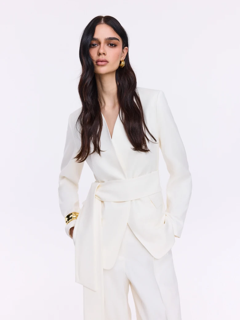 Cream jacket with decorative button and sash