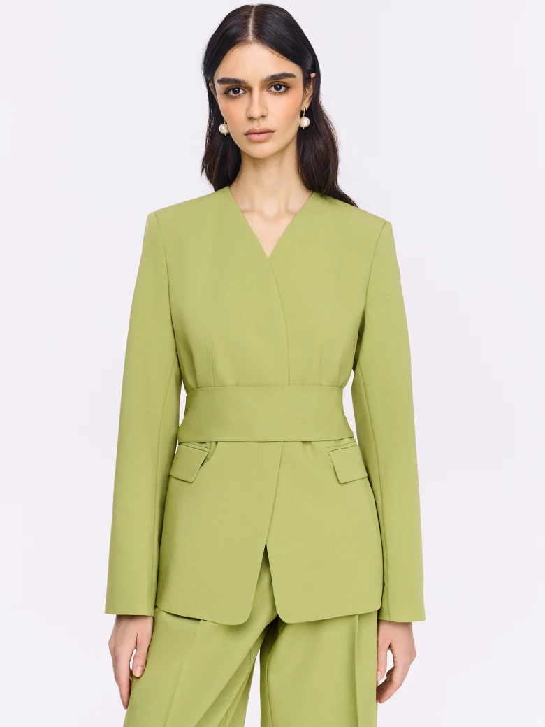 Green jacket with a sash and a jeweled button