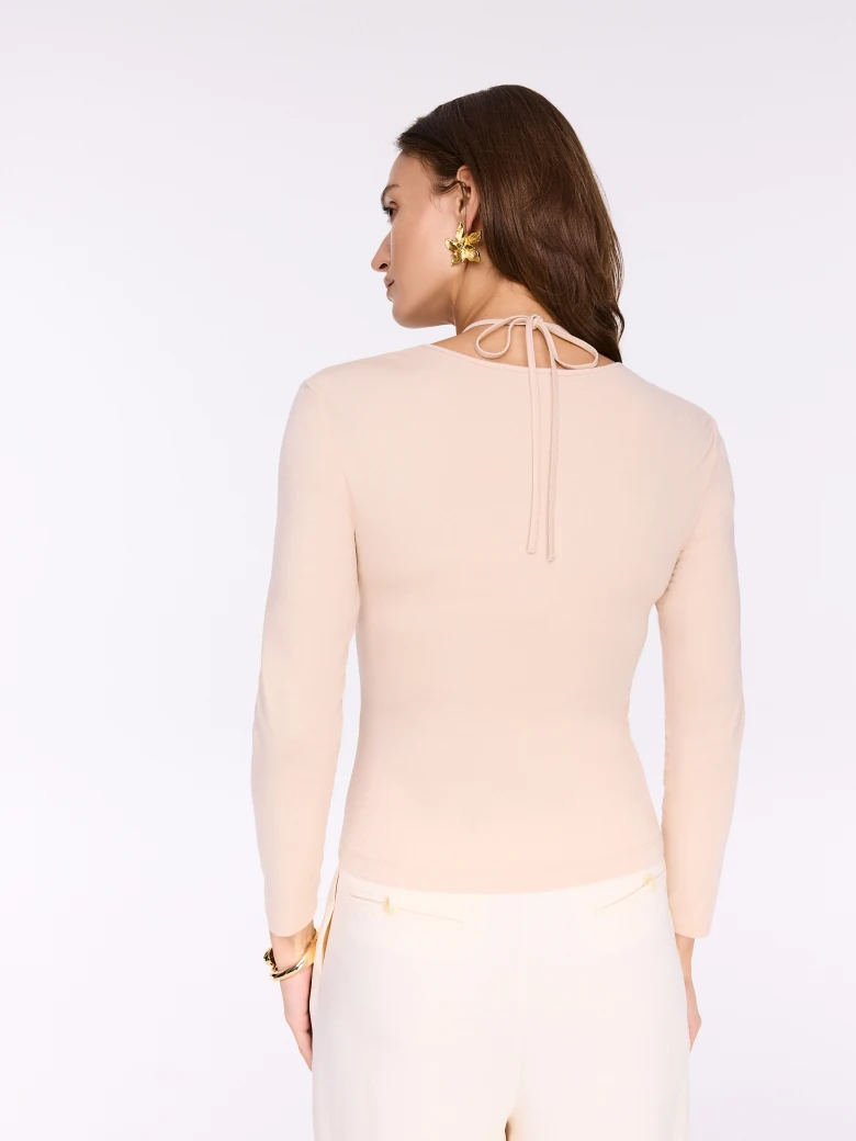 Beige blouse with crease and decorative flower
