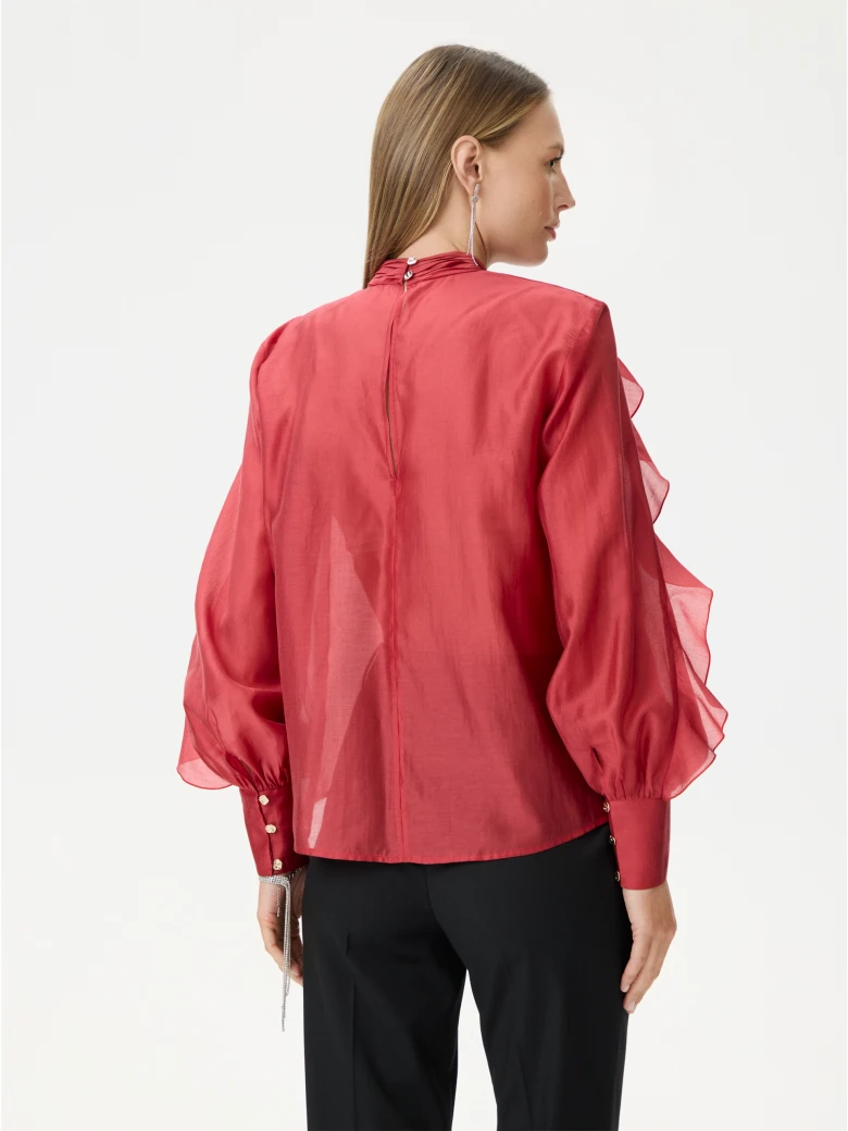 Red satin blouse with decorative ruffles