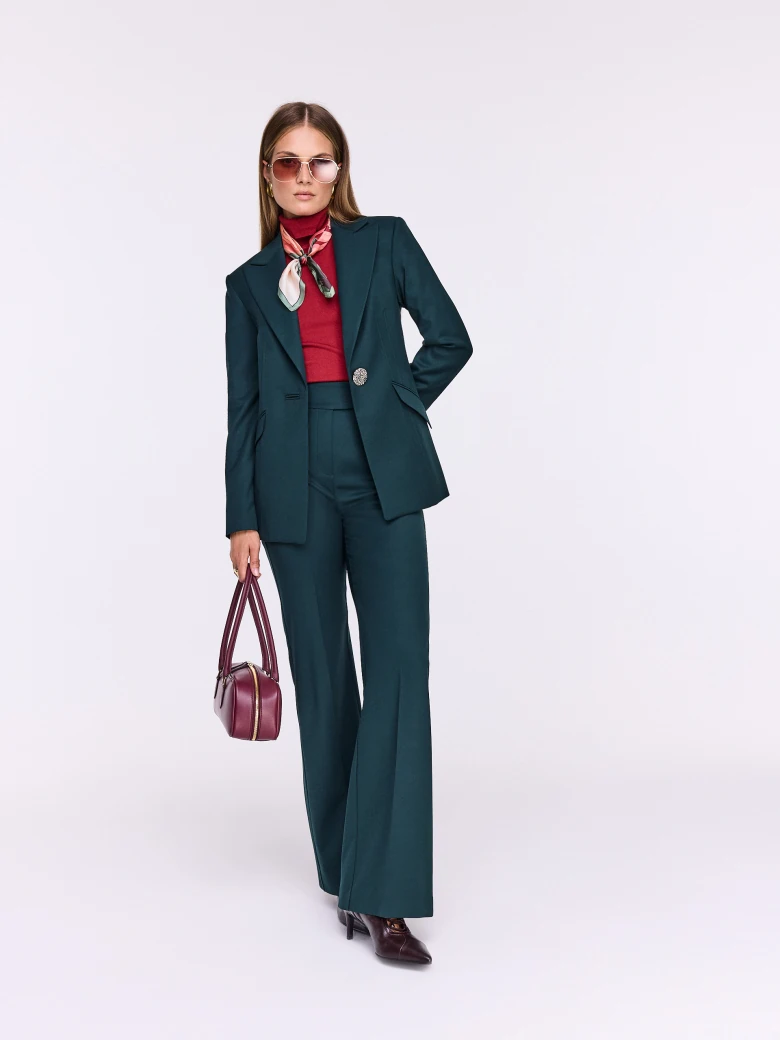 Dark green fitted jacket with decorative button
