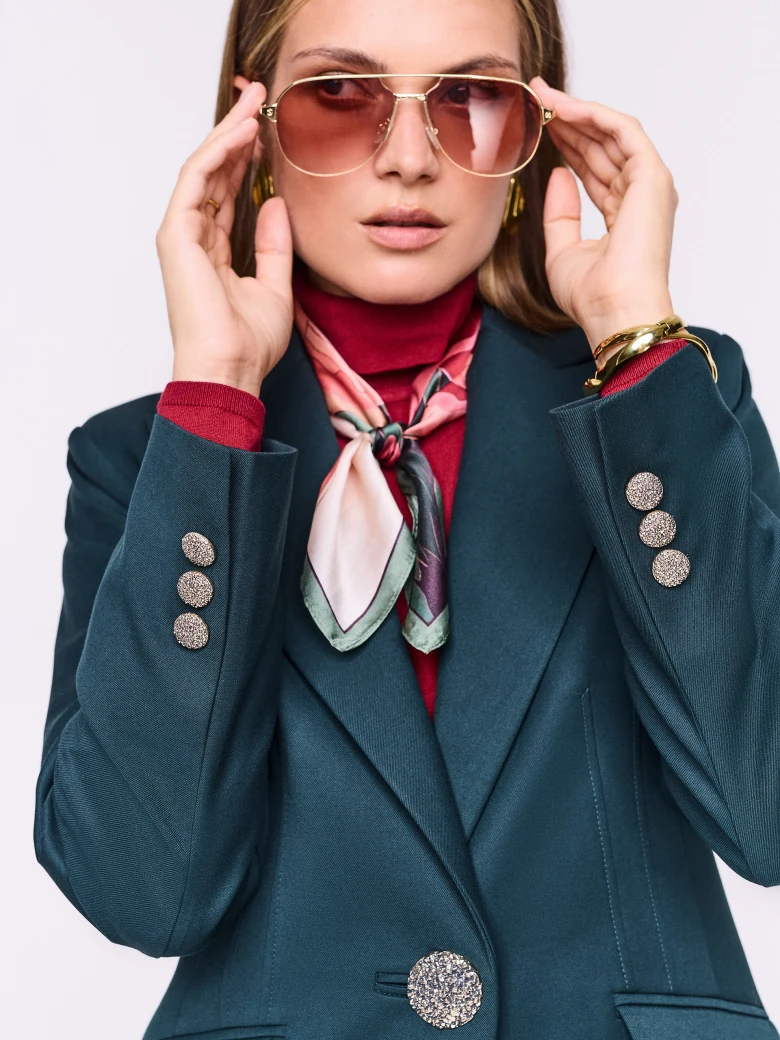 Dark green fitted jacket with decorative button