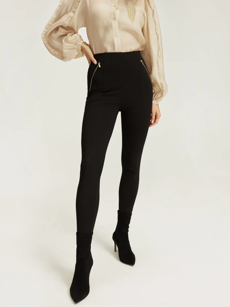 Black fitted pants with zippers