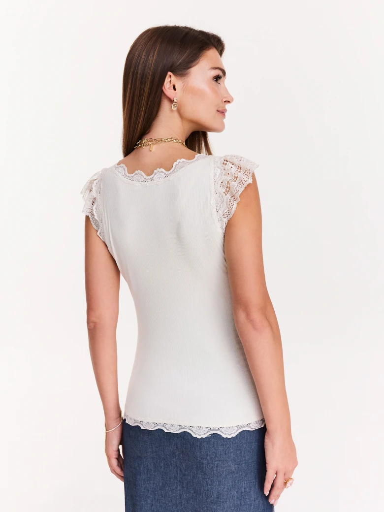 Ribbed white blouse with lace inserts