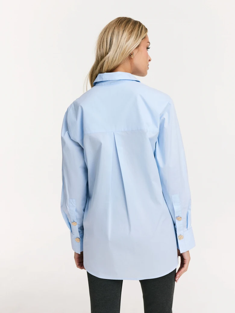 Blue shirt with decorative buttons