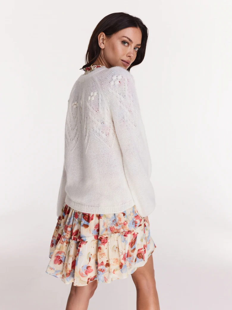 Loose white sweater with round neckline