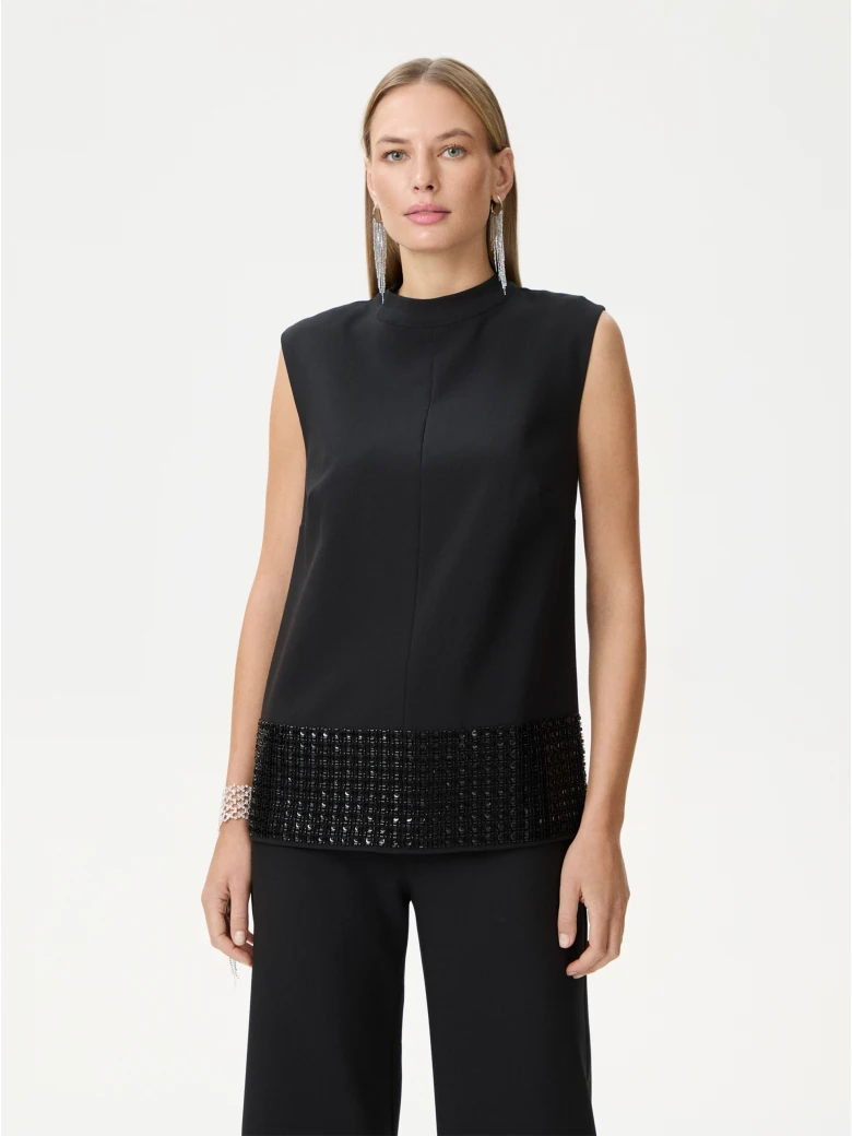 Black sleeveless blouse with decorative trim