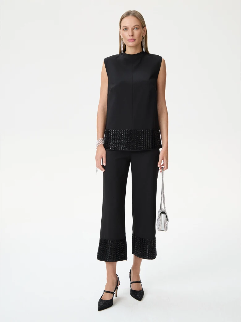 Black sleeveless blouse with decorative trim