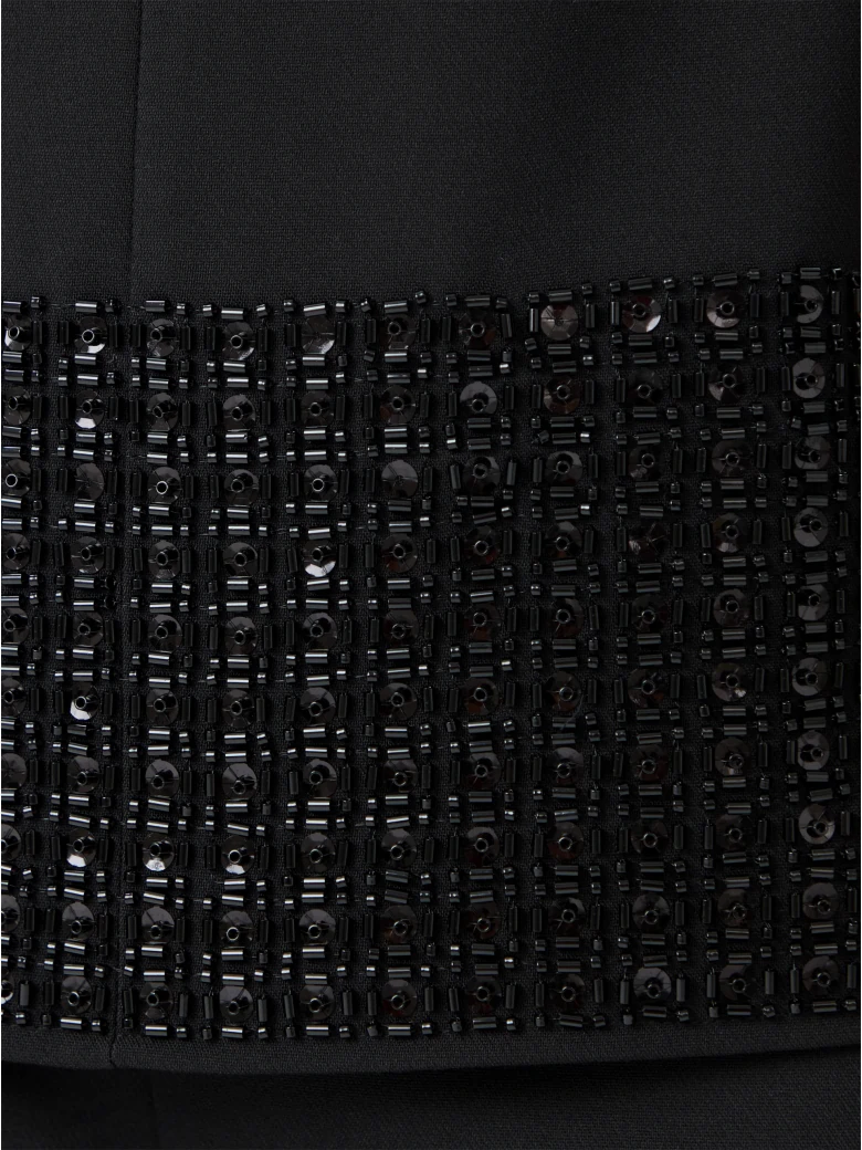 Black sleeveless blouse with decorative trim