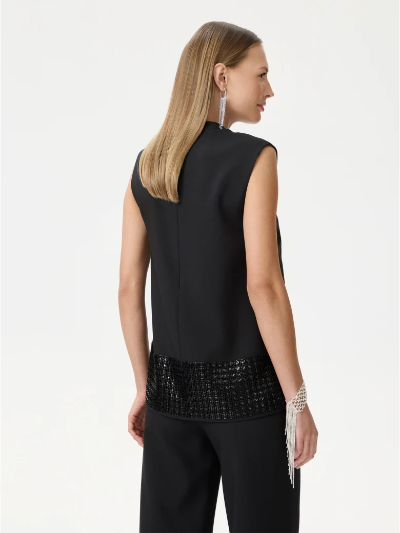 Black sleeveless blouse with decorative trim