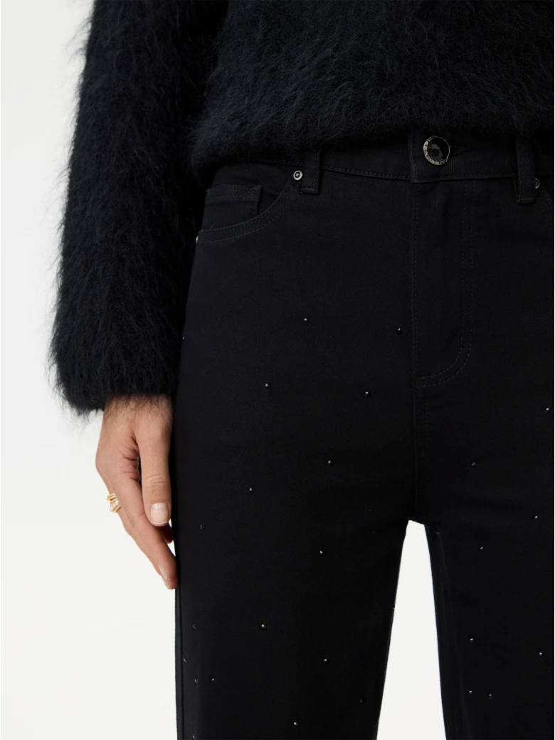 Black bell-bottom pants with shiny detail