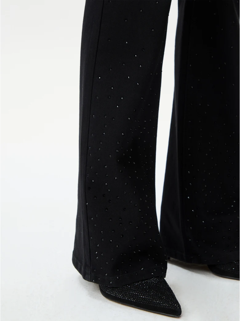 Black bell-bottom pants with shiny detail