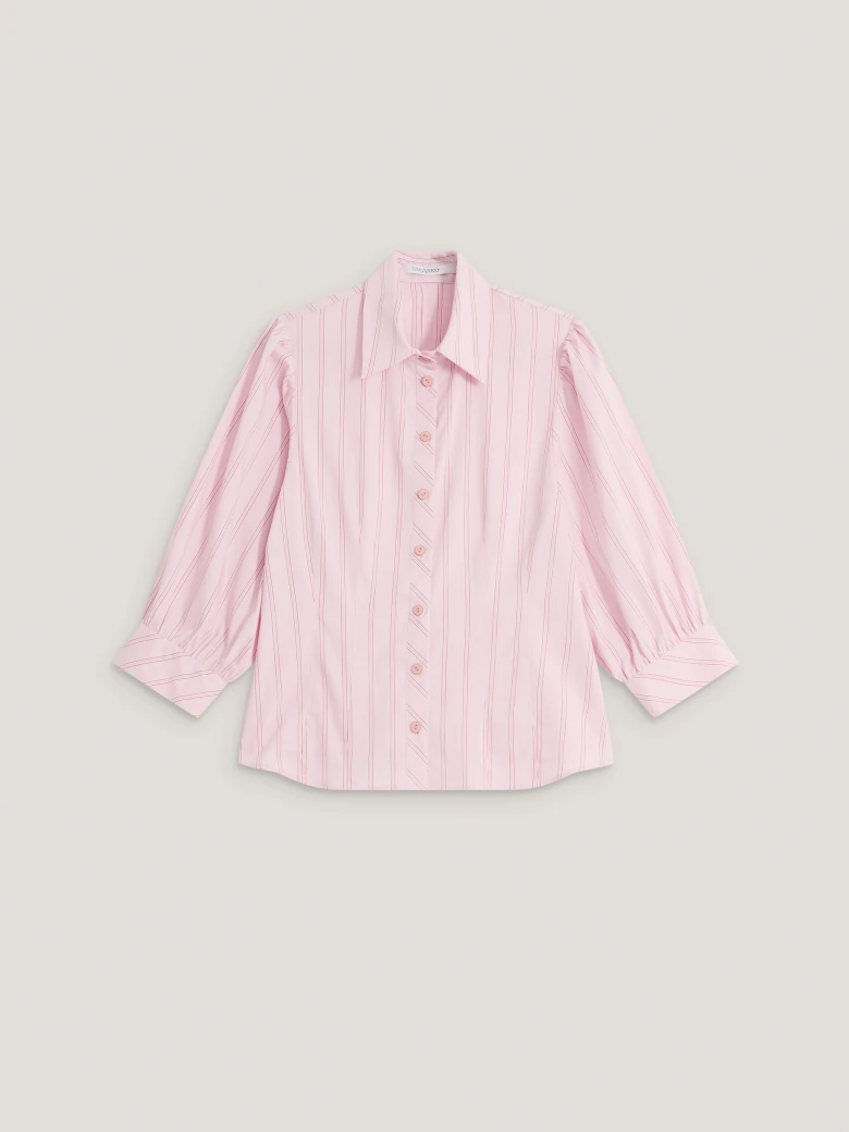 A light pink, fitted, ribbed blouse