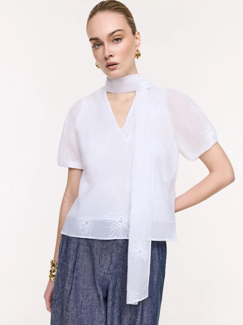 White embroidered blouse with a tie at the neck