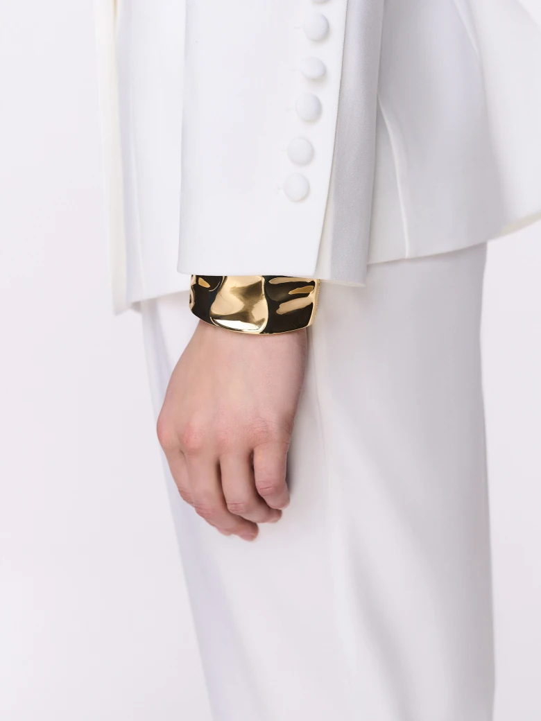 A classic white blazer with a decorative flower
