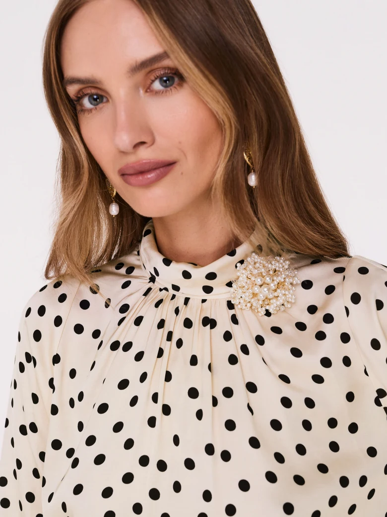 Cream pea blouse with pearl brooch