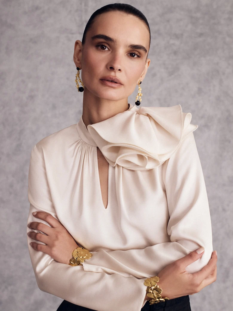 Cream blouse with an eye-catching flower appliqué