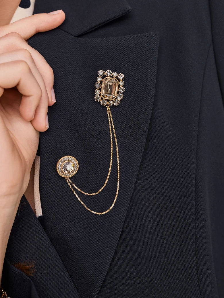 Brooch with jewelry pins connected by a chain