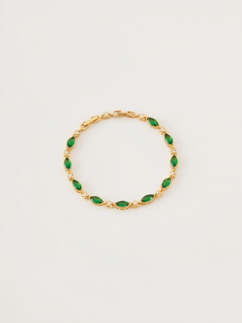 Bracelet in gold color with green crystals