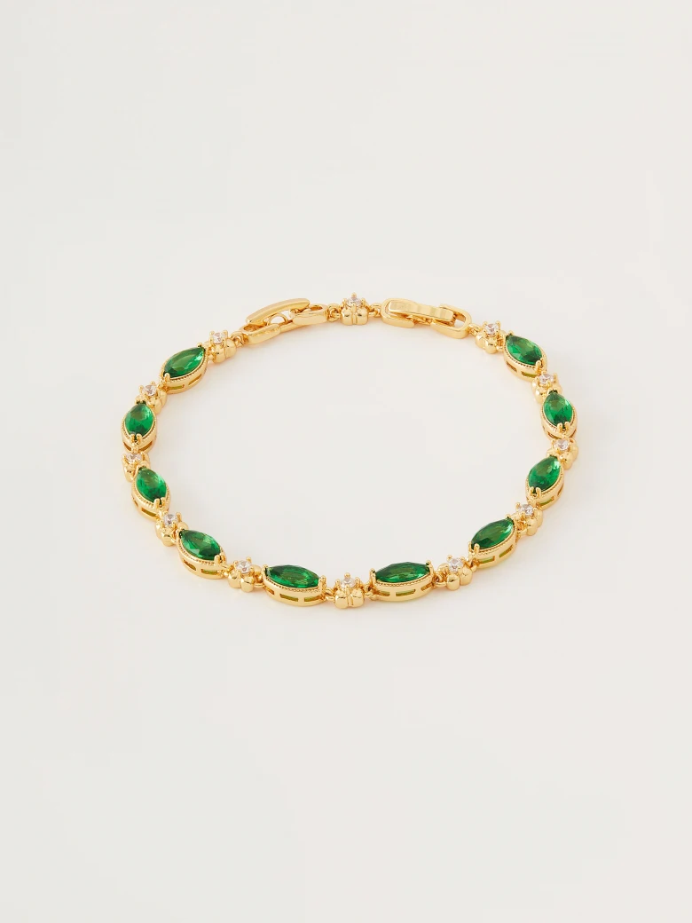 Bracelet in gold color with green crystals