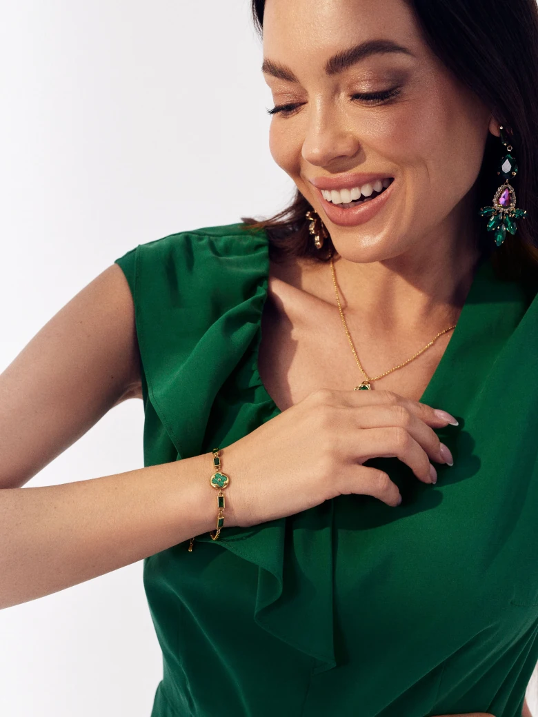 Gold color bracelet with green stones
