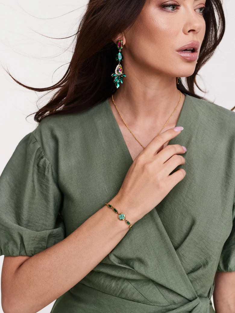 Gold color bracelet with green stones