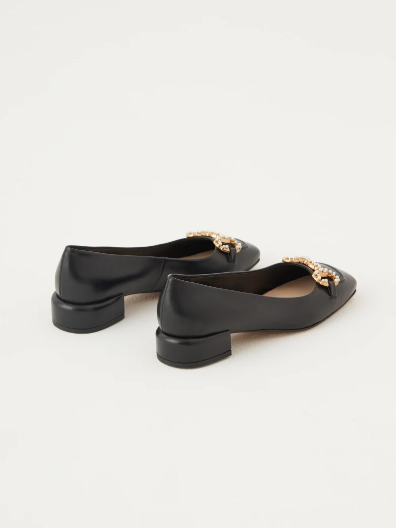 Black leather ballerinas decorated with buckles