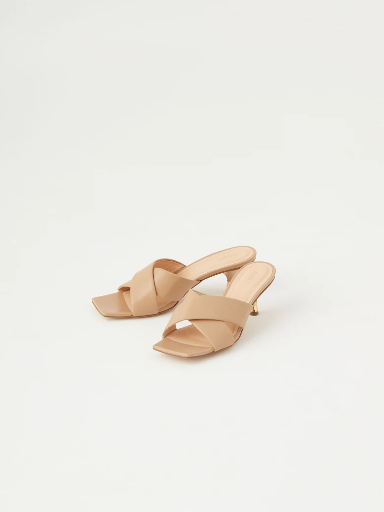 Beige flip-flops with decorative gold element on the heel